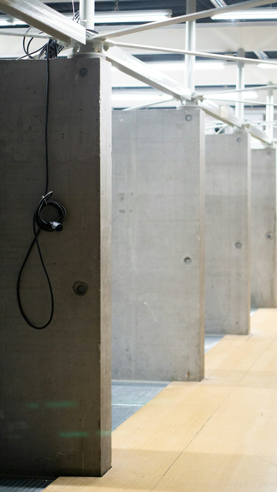 Empty broadcast studio floor with acoustic wall panels and cable trunking